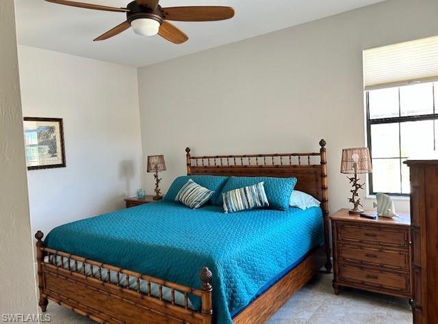 Carpeted bedroom with ceiling fan