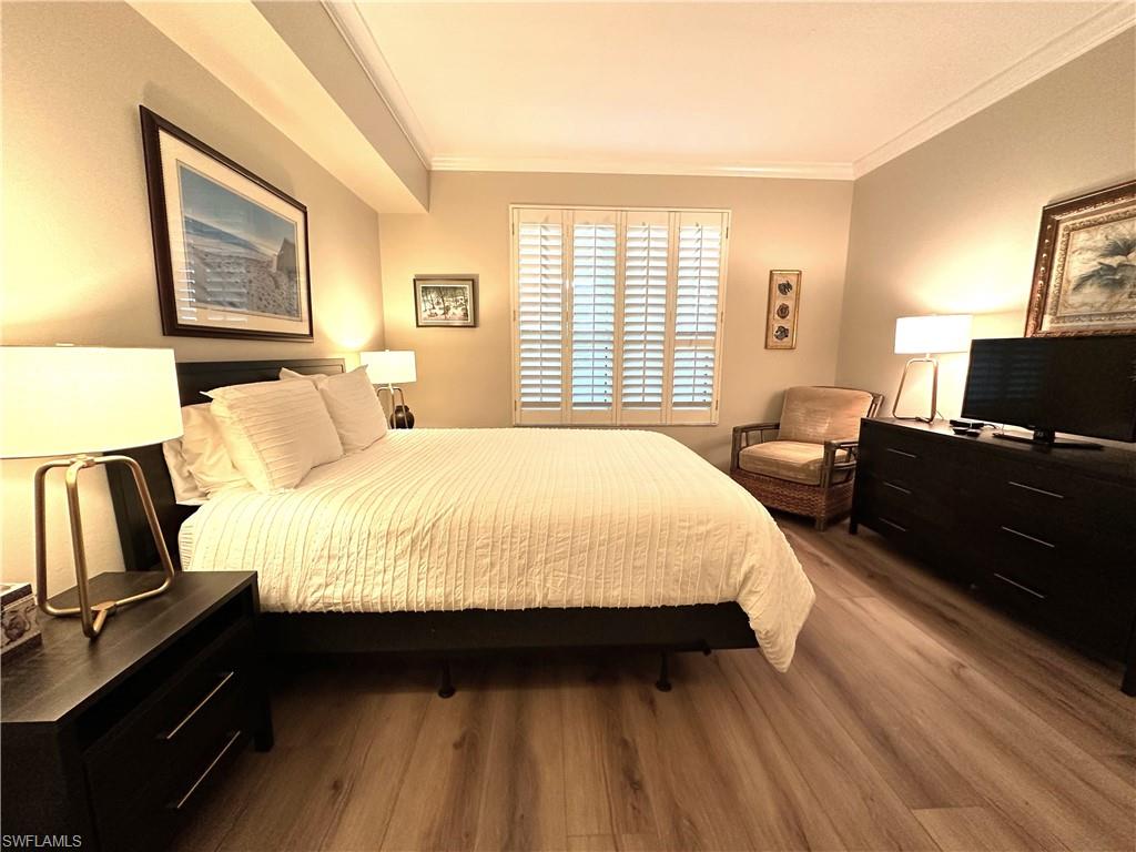 Bedroom featuring vinyl flooring and crown molding