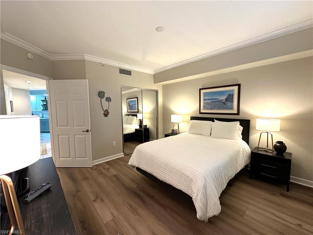 Bedroom featuring vinyl flooring and ornamental molding