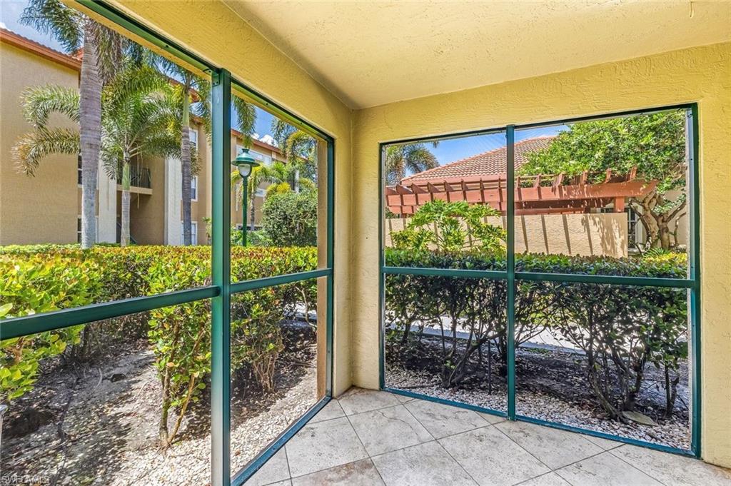 Screened lanai featuring tile flooring and textured walls, and view of the community pool area.