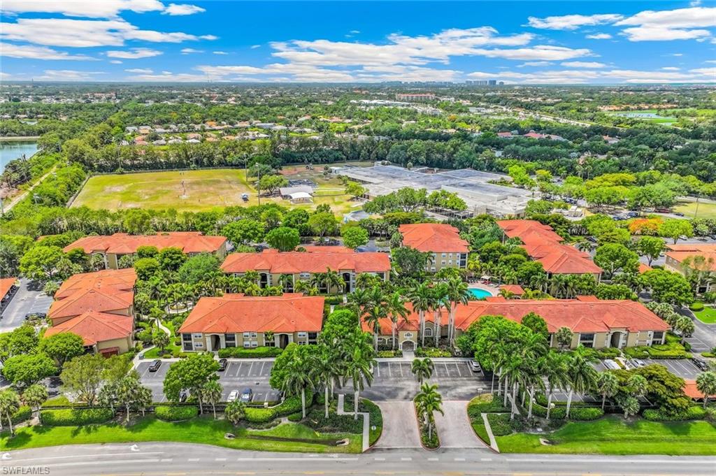 Aerial perspective showcasing the community of San Mirage with numerous multi-story buildings, each featuring terra cotta tile roofs