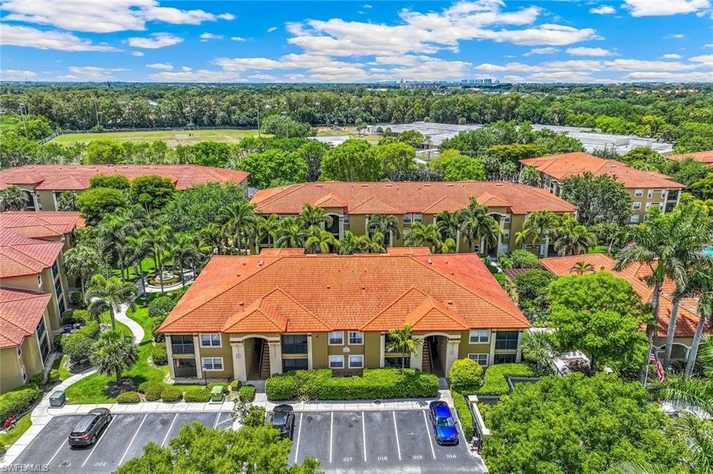 Aerial perspective of the San Mirage residential complex featuring terracotta-style roofing and lush, mature landscaping