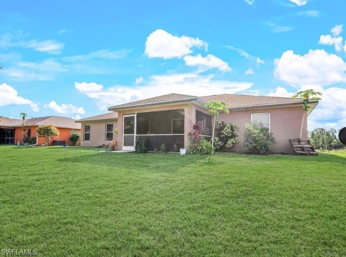 Expansive green lawn with a screened-in rear patio