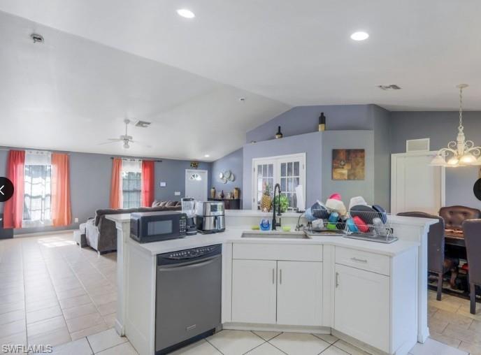 Kitchen island featuring white cabinetry, a stainless steel dishwasher, and a black faucet