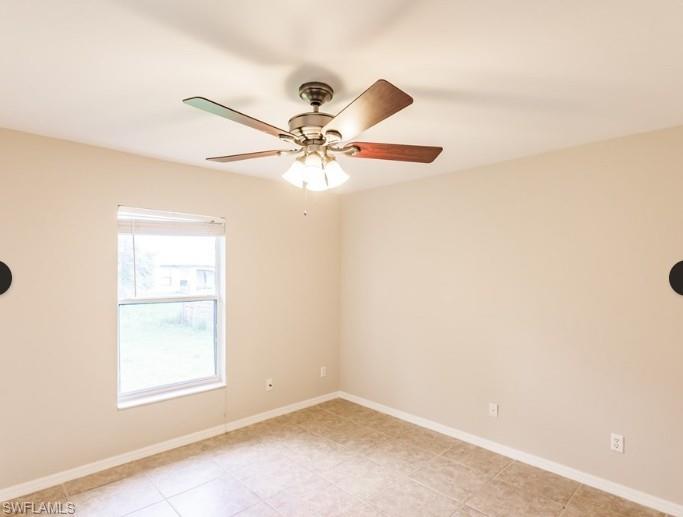 Neutral-toned room featuring a single window, a ceiling fan with integrated lighting, and tile flooring