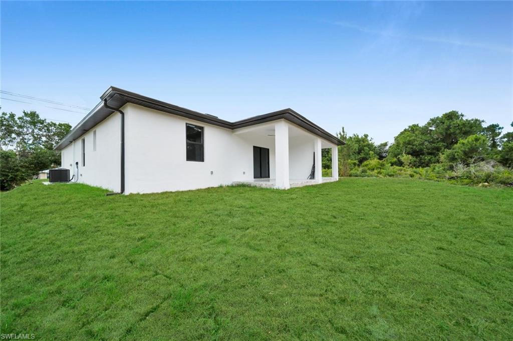Modern single-story exterior with white stucco finish and dark trim