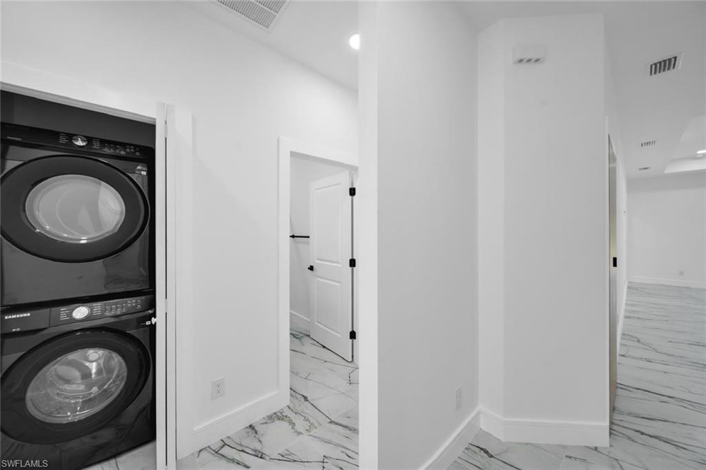 Stackable front-load washer and dryer set within a dedicated alcove