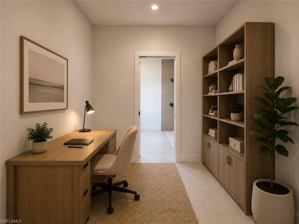 Dedicated study area featuring a built-in wood-finish desk with drawers, matching built-in shelving with lower cabinetry, recessed lighting, and a textured area rug