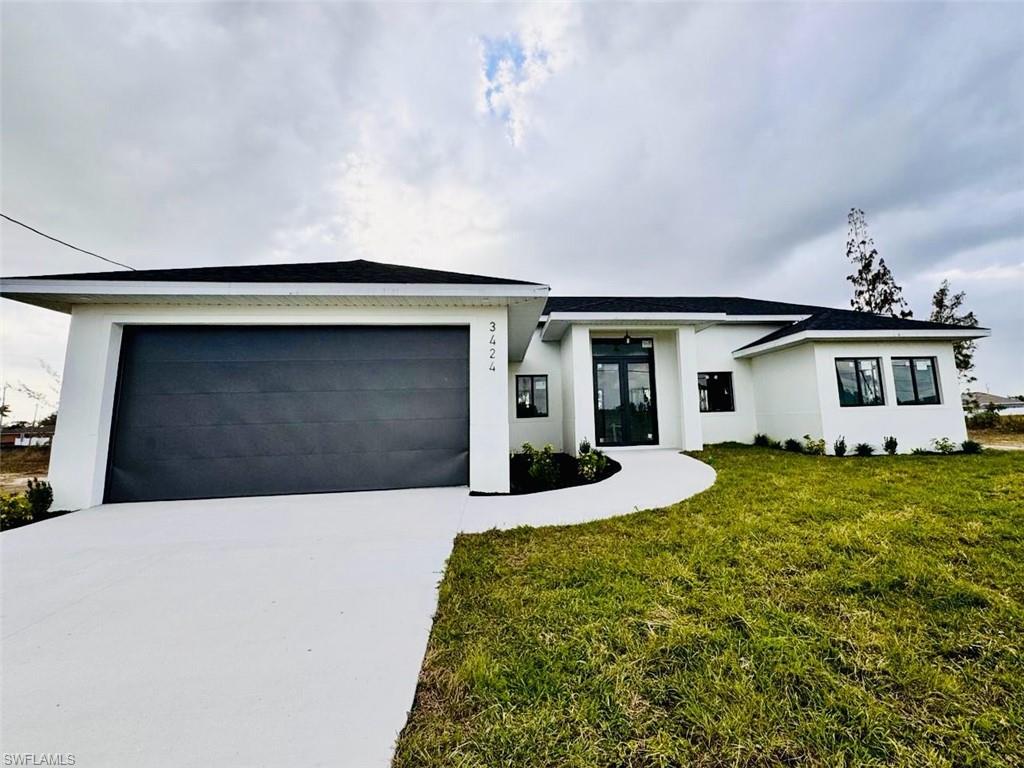 Contemporary single-story home featuring a white stucco exterior