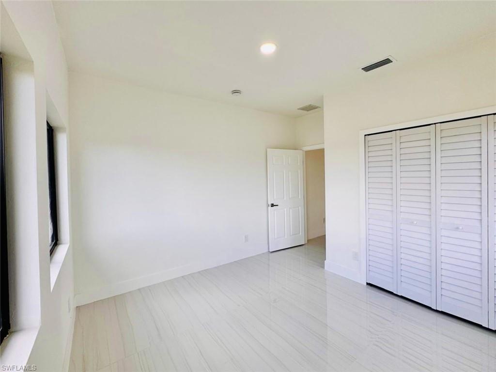 Interior room featuring a contemporary white color palette and polished tile flooring