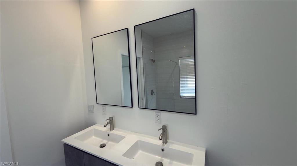 Dual vanity featuring integrated rectangular sinks and brushed nickel faucets