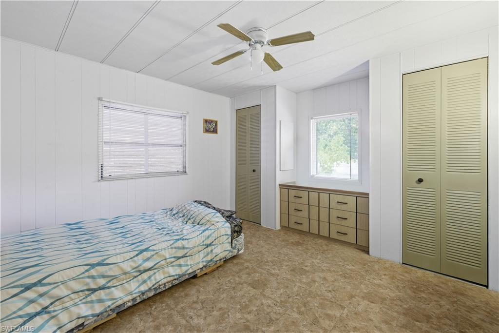 Interior room featuring textured panel walls and a ceiling fan