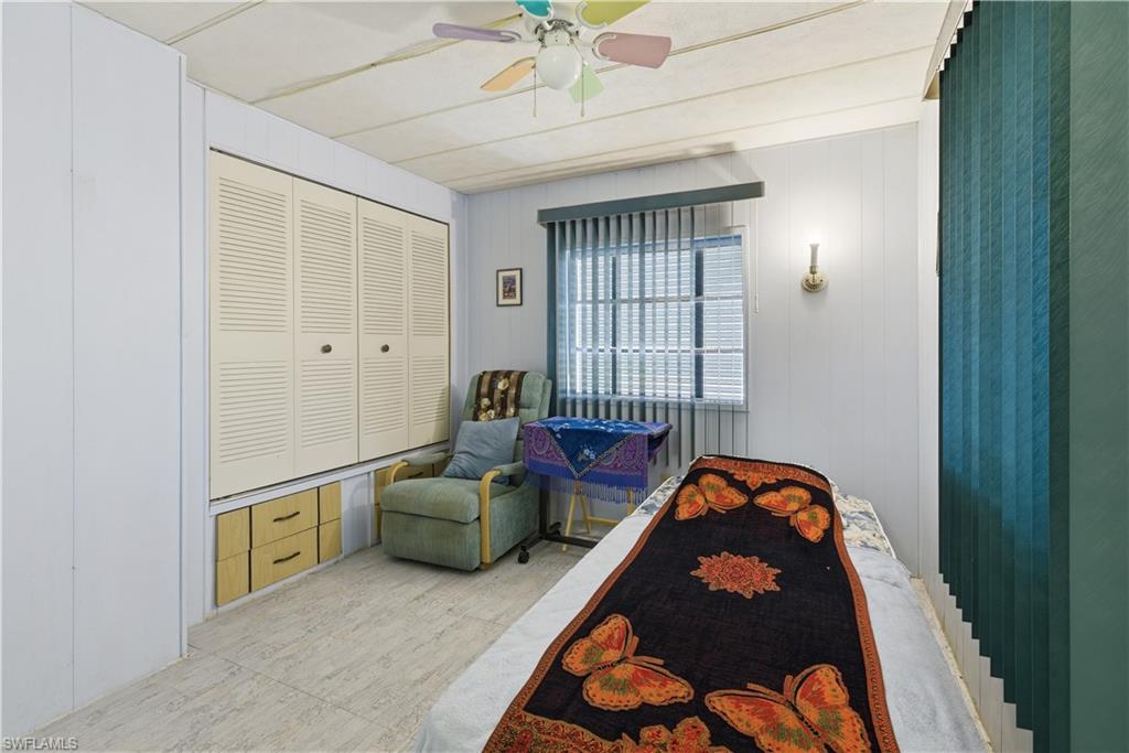 Louvered bi-fold closet doors with storage drawers beneath