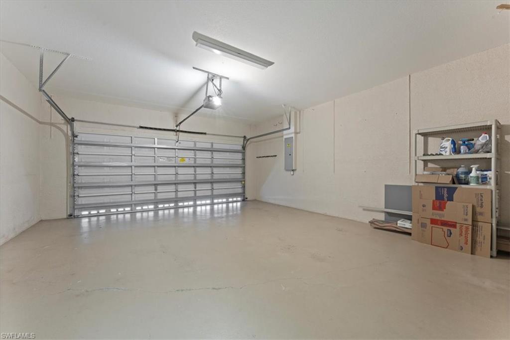 Garage with electric panel and a garage door opener