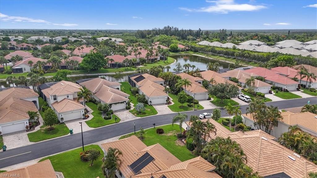 Aerial view of residential area featuring a nearby body of water