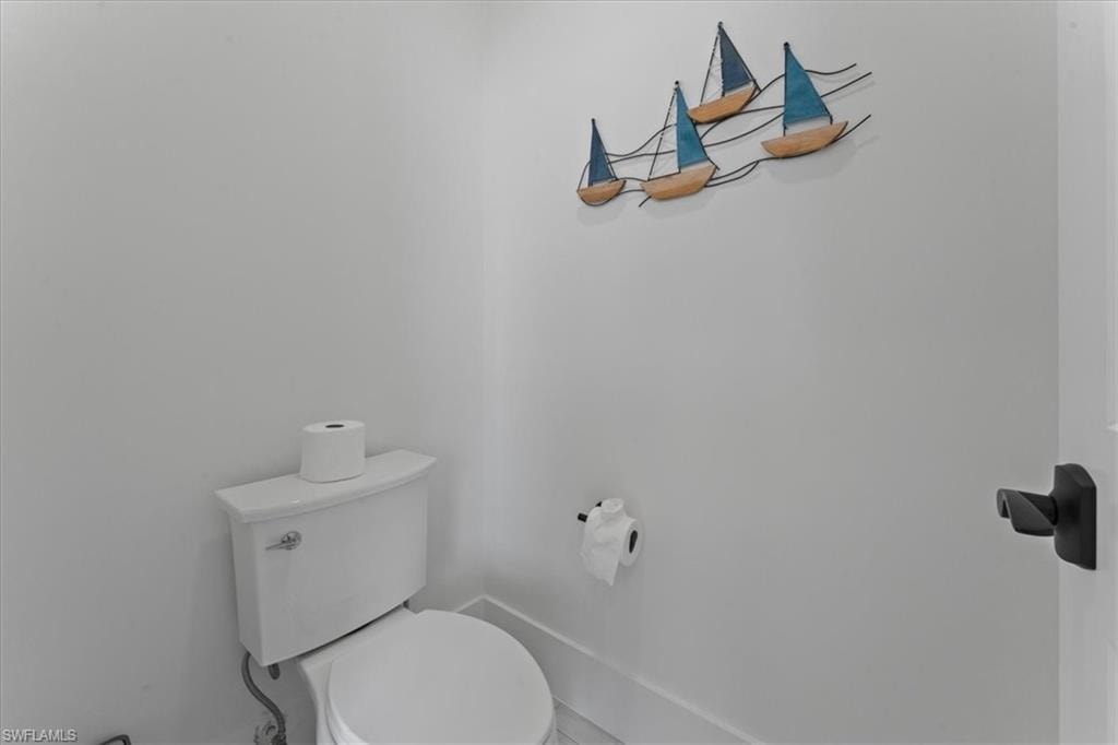 Bathroom featuring toilet and baseboards
