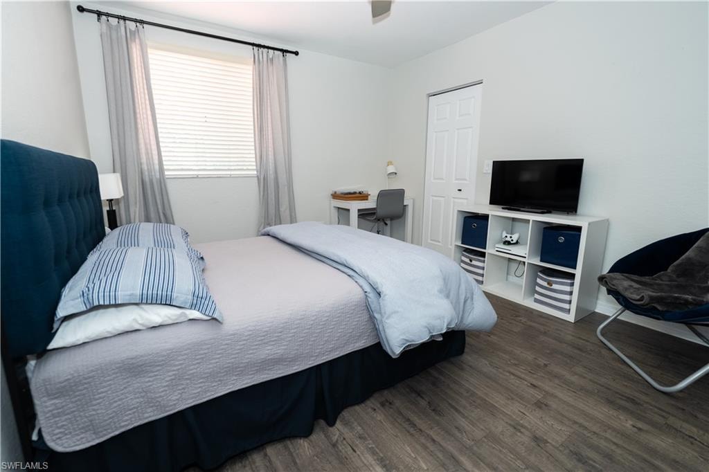 Wood-finish flooring with white walls and a white paneled door