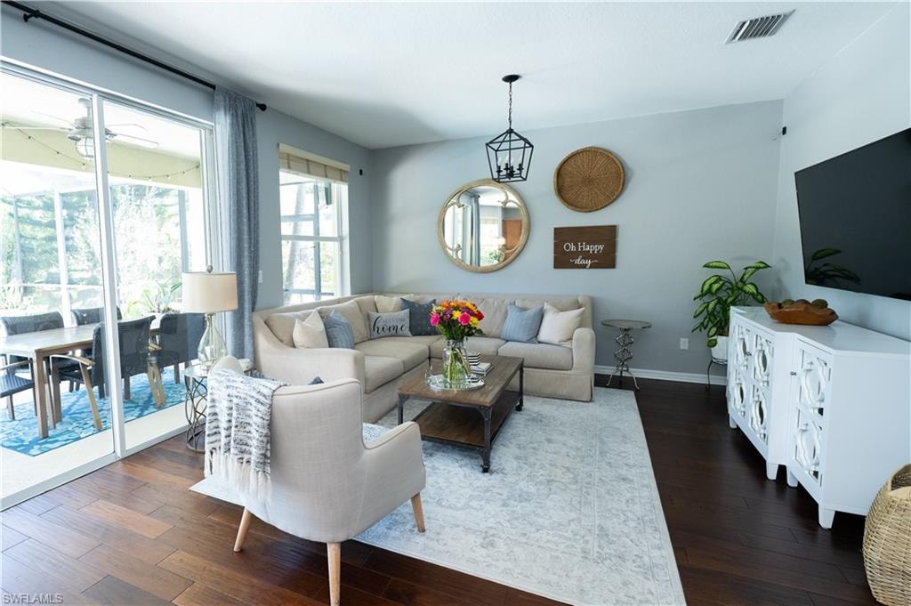 Spacious living area featuring wood-finish flooring and light-toned walls