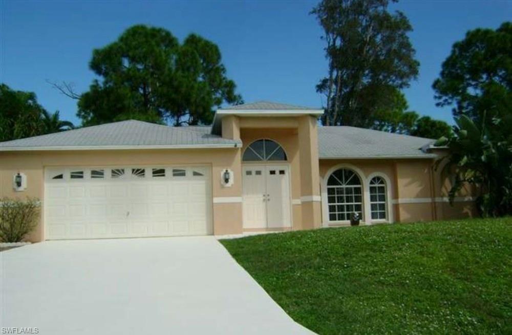 Single-story residence featuring a neutral stucco exterior with decorative banding