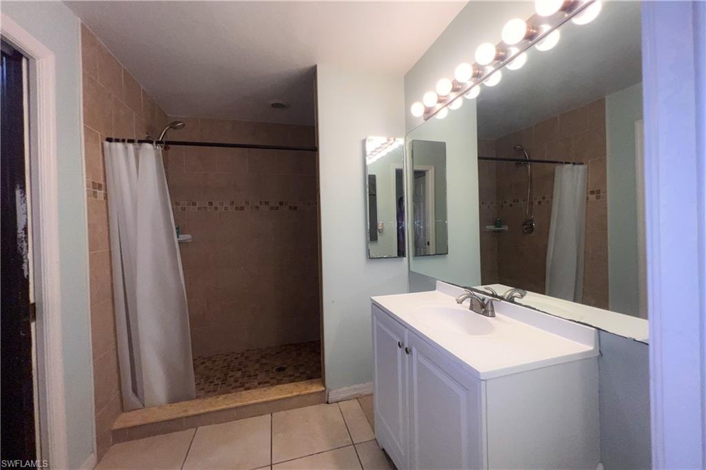 Bathroom vanity featuring a white countertop and cabinet storage