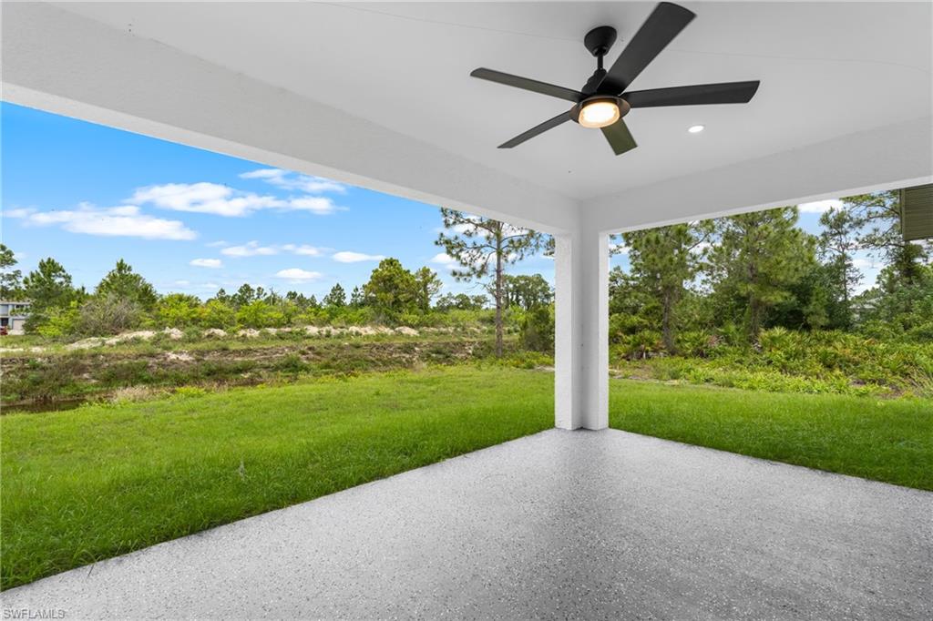 Covered outdoor living area with a dark-finished ceiling fan and recessed lighting
