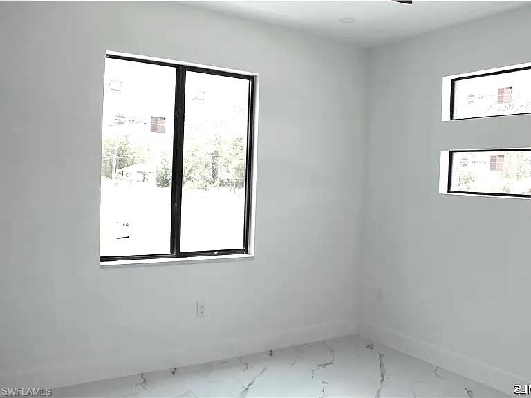 Bright interior space featuring a large picture window and two horizontal accent windows