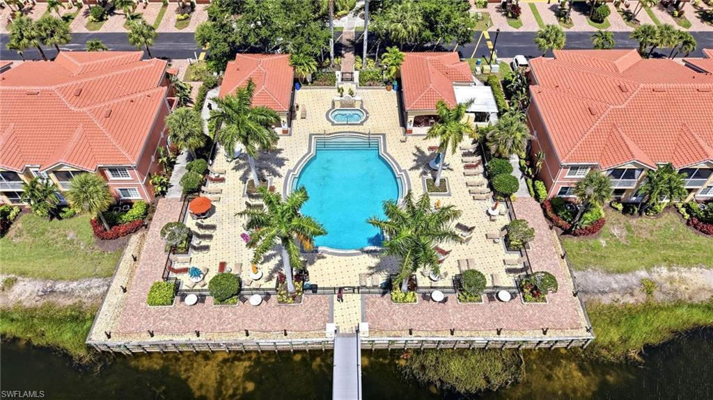 Crystal Clear Pool and Spa with showers, restrooms, lounge chairs, tables and umbrellas