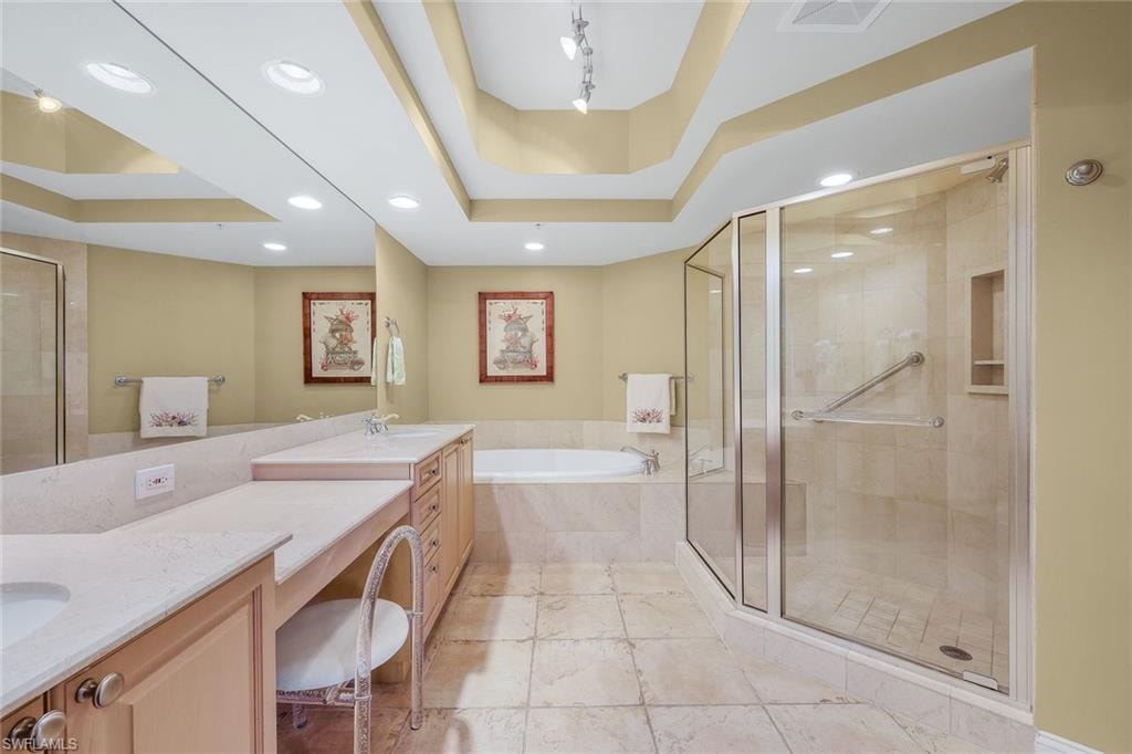 Primary bathroom features a walk-in shower, dual vanity and soaking tub.