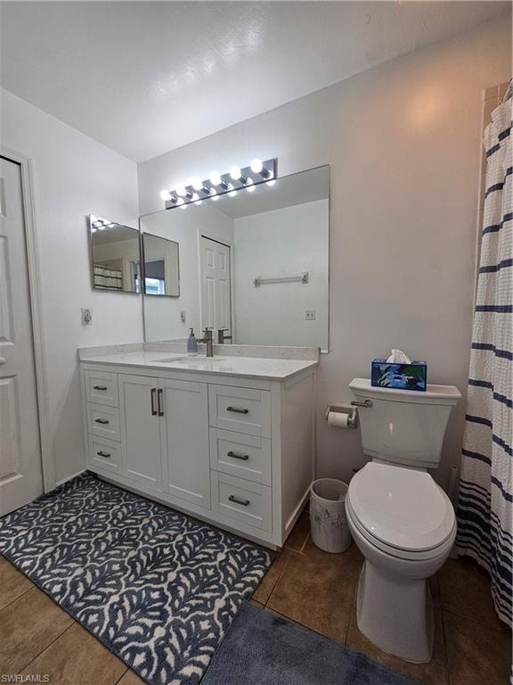 White vanity with a light-toned countertop, under-mount sink, and dark hardware