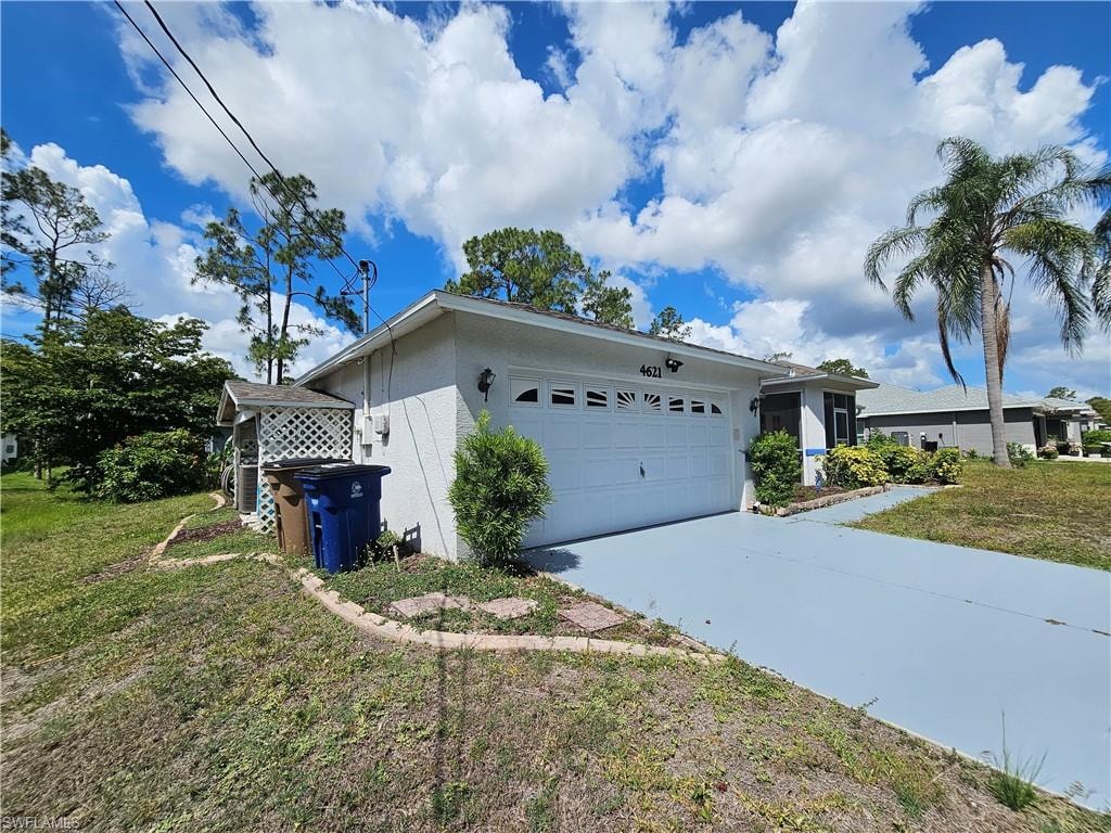 Single-story residence featuring a white exterior and a two-car garage