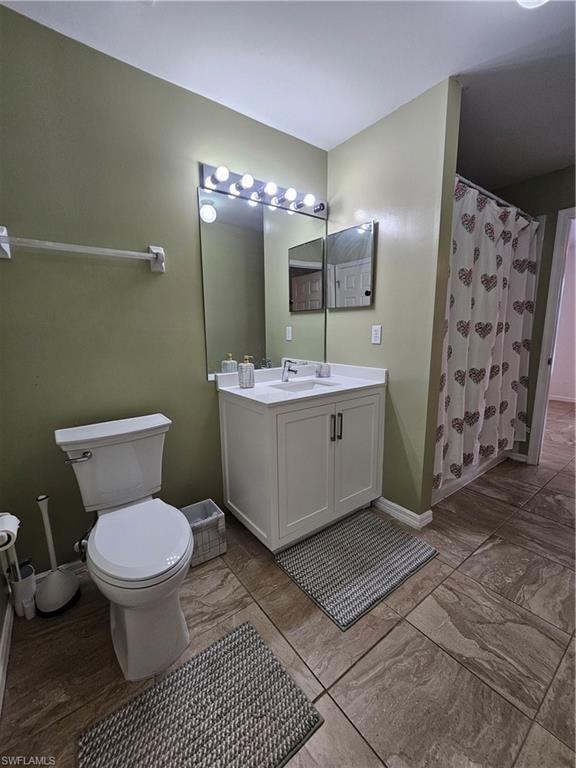 Bathroom featuring a white vanity with integrated sink, a large wall-mounted mirror, and tile flooring