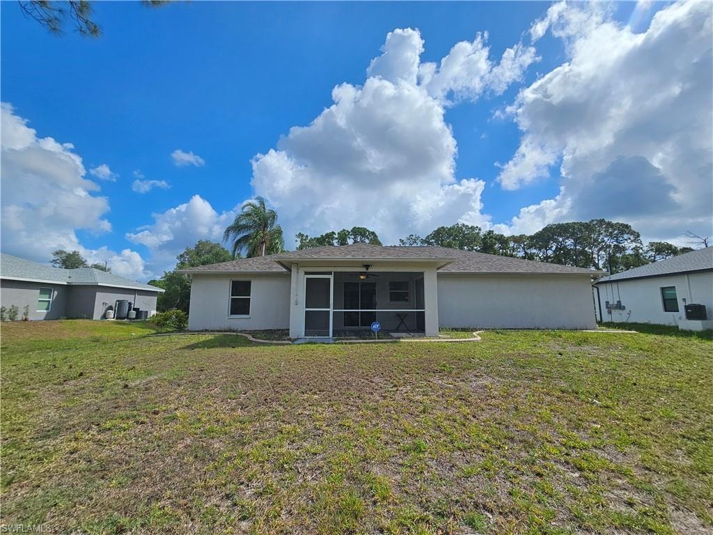 Rear exterior of a single-story residence with a screened patio