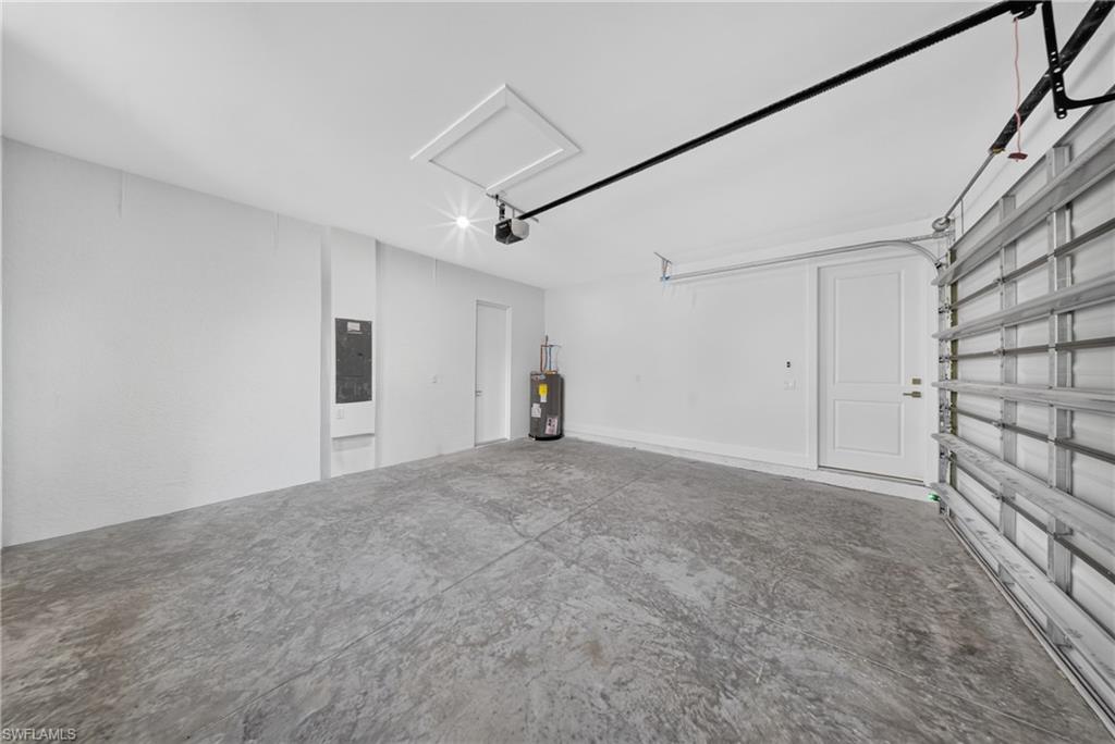 Spacious garage featuring concrete flooring and white walls