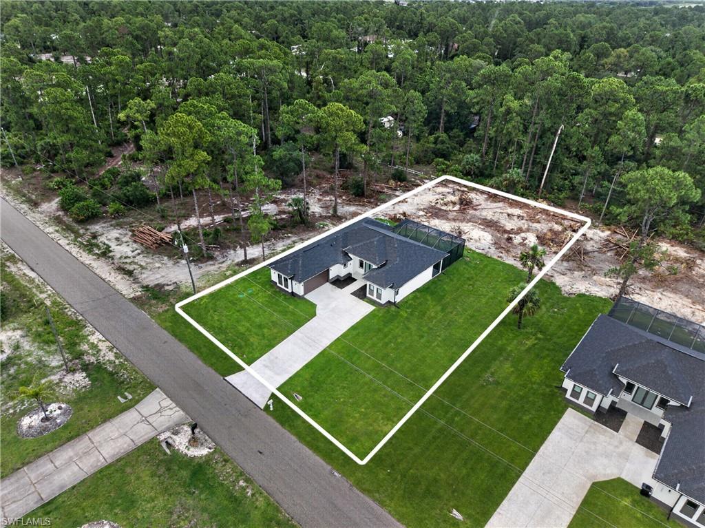 Modern single-story residence featuring a dark shingle roof and white exterior