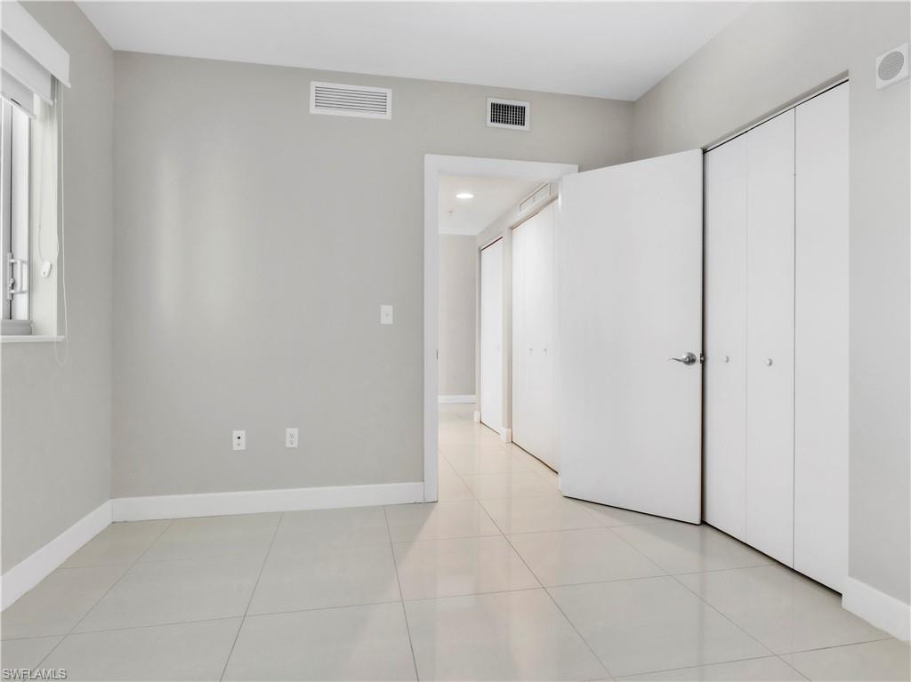 Unfurnished bedroom with light tile patterned floors and a closet
