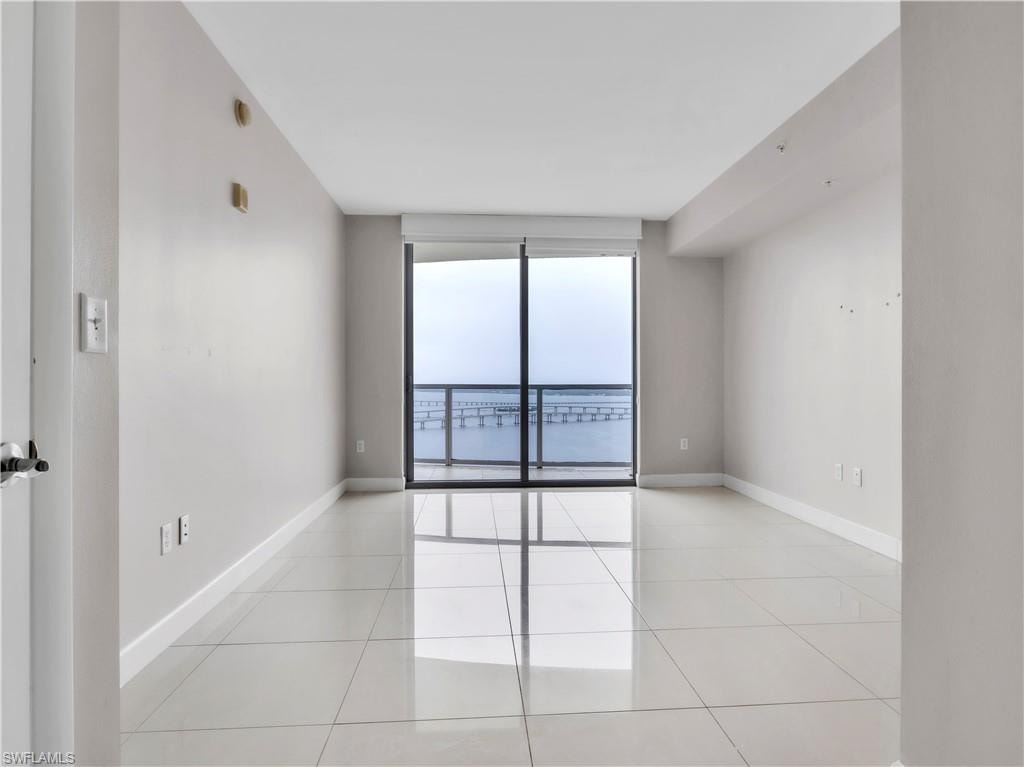 Empty room with light tile patterned flooring