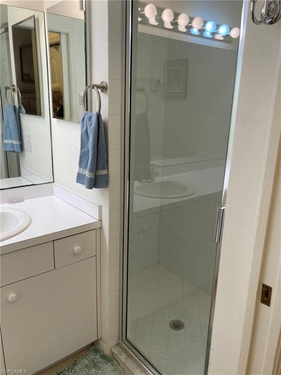 Bathroom featuring vanity and a stall shower