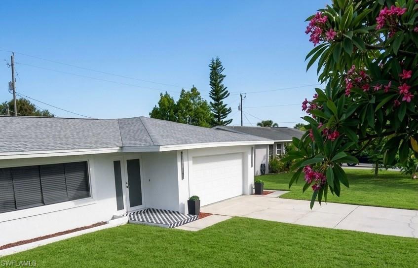 Contemporary exterior featuring a newly installed shingle roof, integrated garage, and a concrete driveway