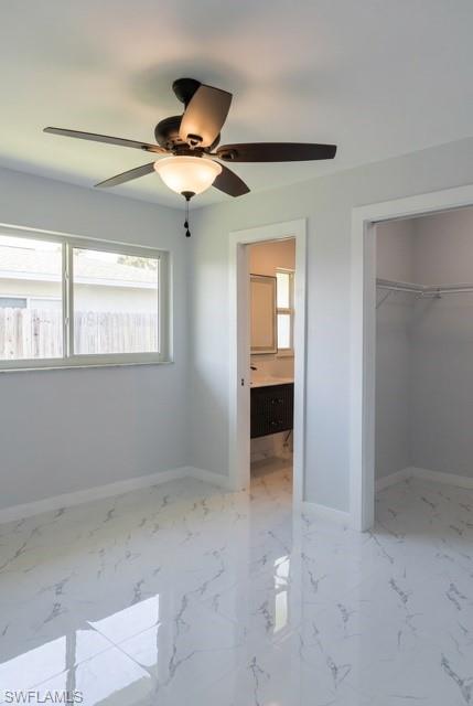 Room featuring polished white tile flooring with grey veining, a ceiling fan with integrated lighting, and light grey wall finishes