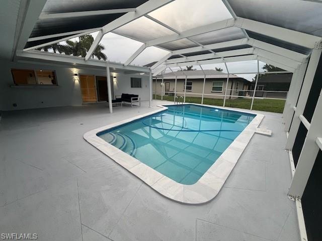 Screened enclosure featuring a rectangular swimming pool with curved corners and light-toned coping