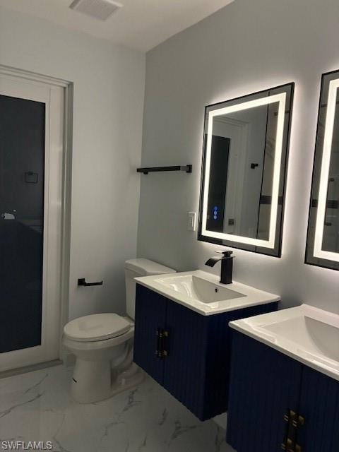 Dual floating vanity sinks with white countertops and matte black fixtures, illuminated by backlit mirrors