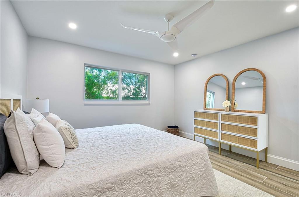 Bedroom with ceiling fan and hardwood / wood-style floors