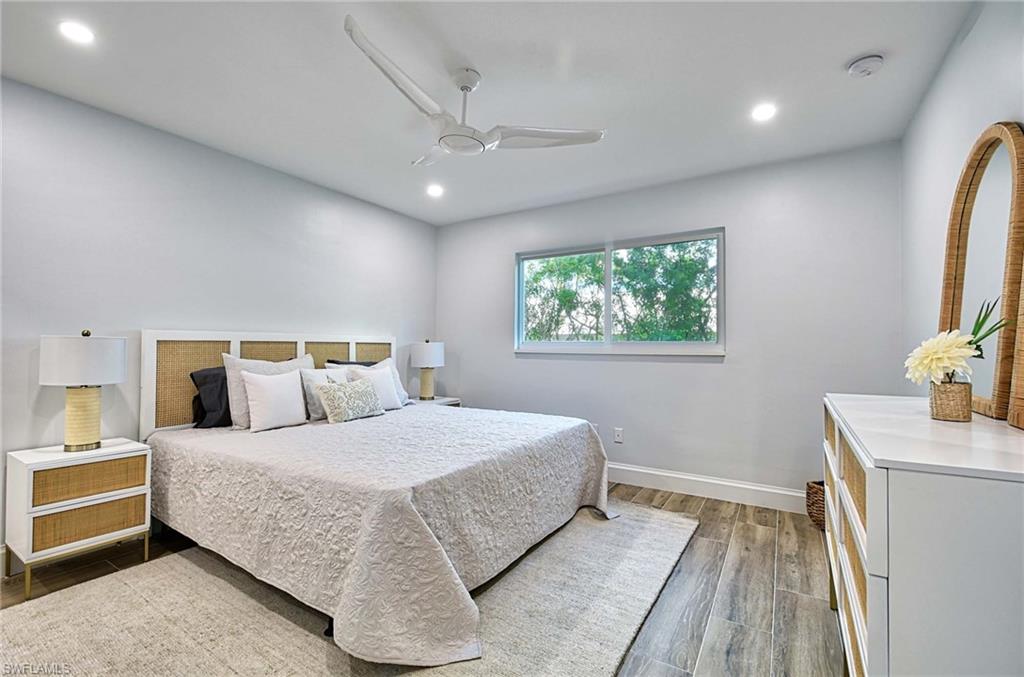 Bedroom with dark wood-type flooring and ceiling fan