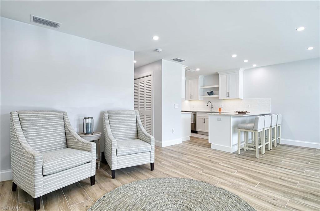 Sitting room featuring sink and light hardwood / wood-style flooring