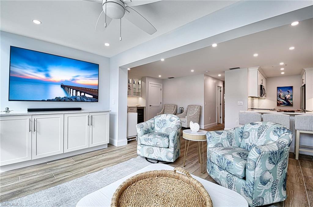 Living room featuring ceiling fan and light hardwood / wood-style floors