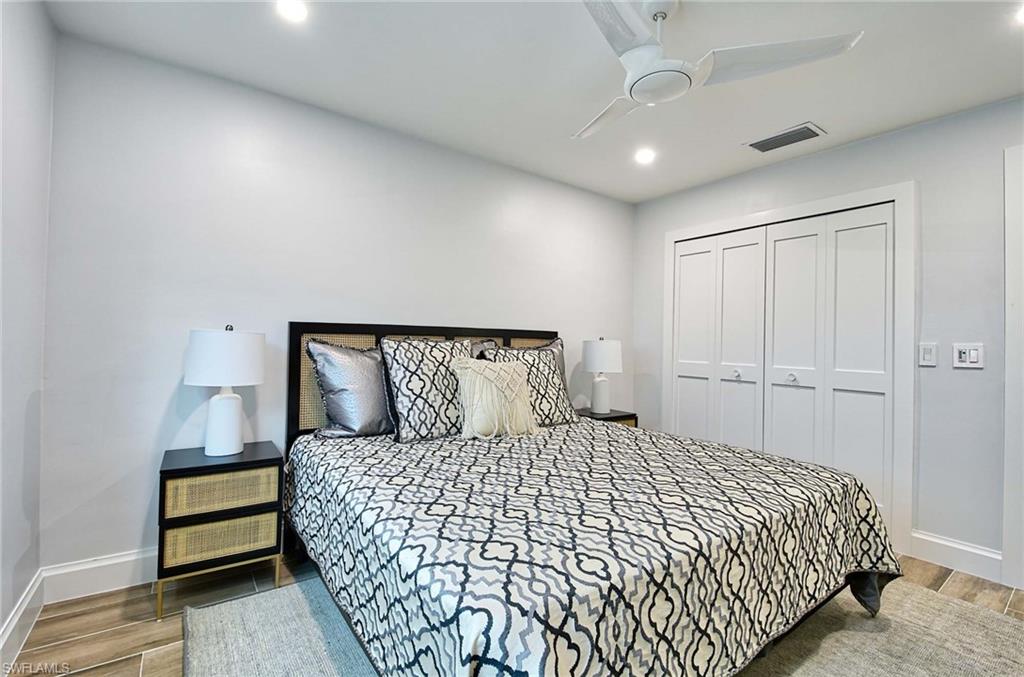Bedroom with ceiling fan, a closet, and hardwood / wood-style flooring