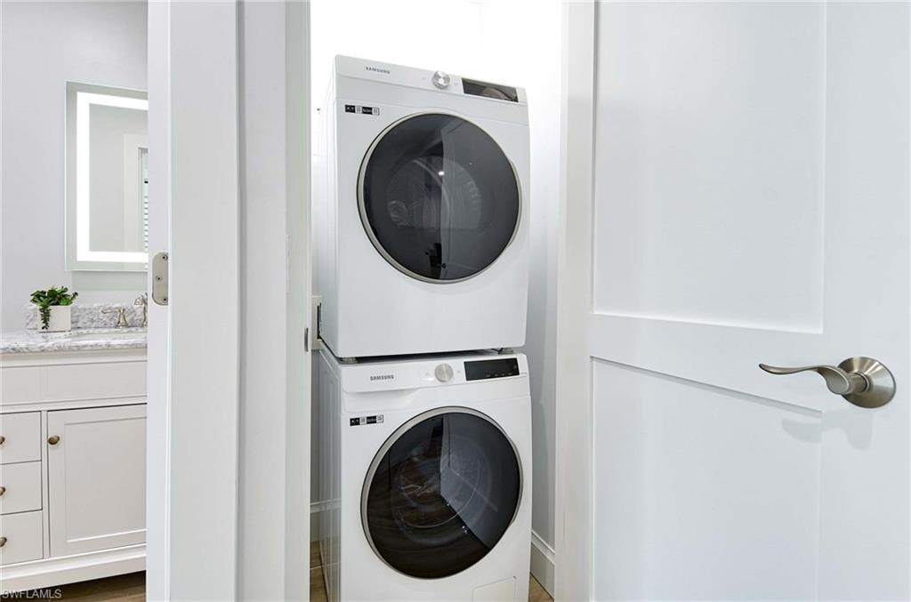 Washroom featuring stacked washer / dryer