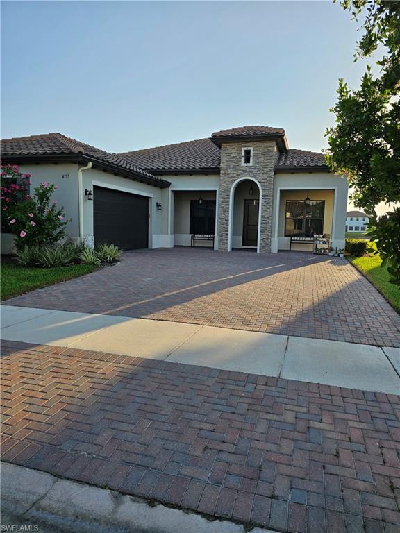 Mediterranean / spanish-style home featuring a garage