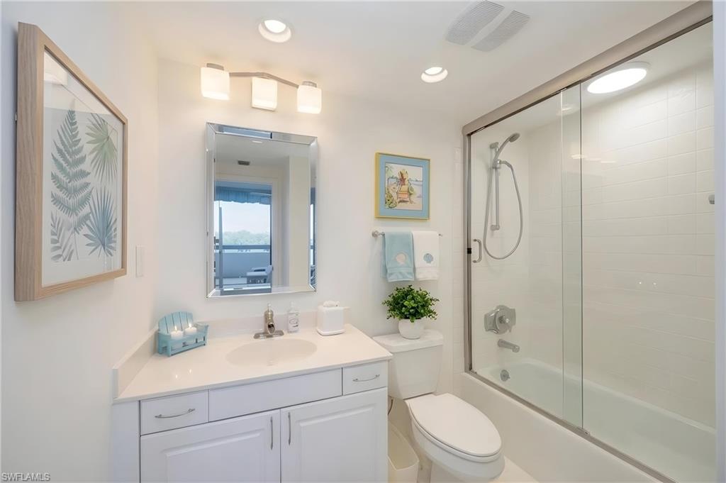 White vanity with undermount sink and quartz-finish countertop