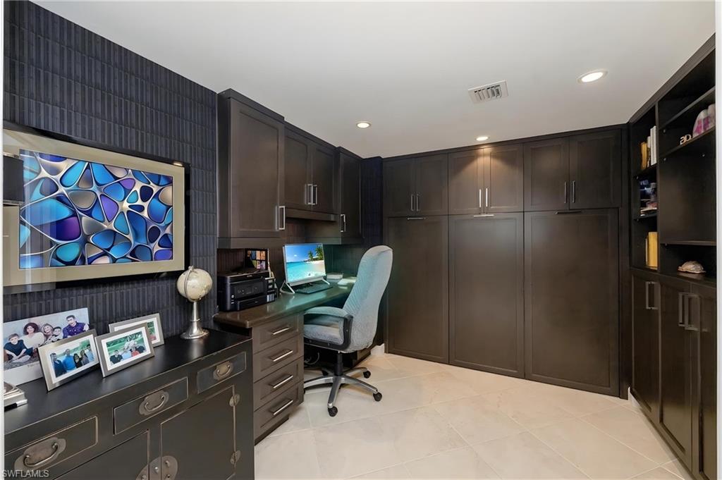 Custom built-in cabinetry and shelving define this versatile room